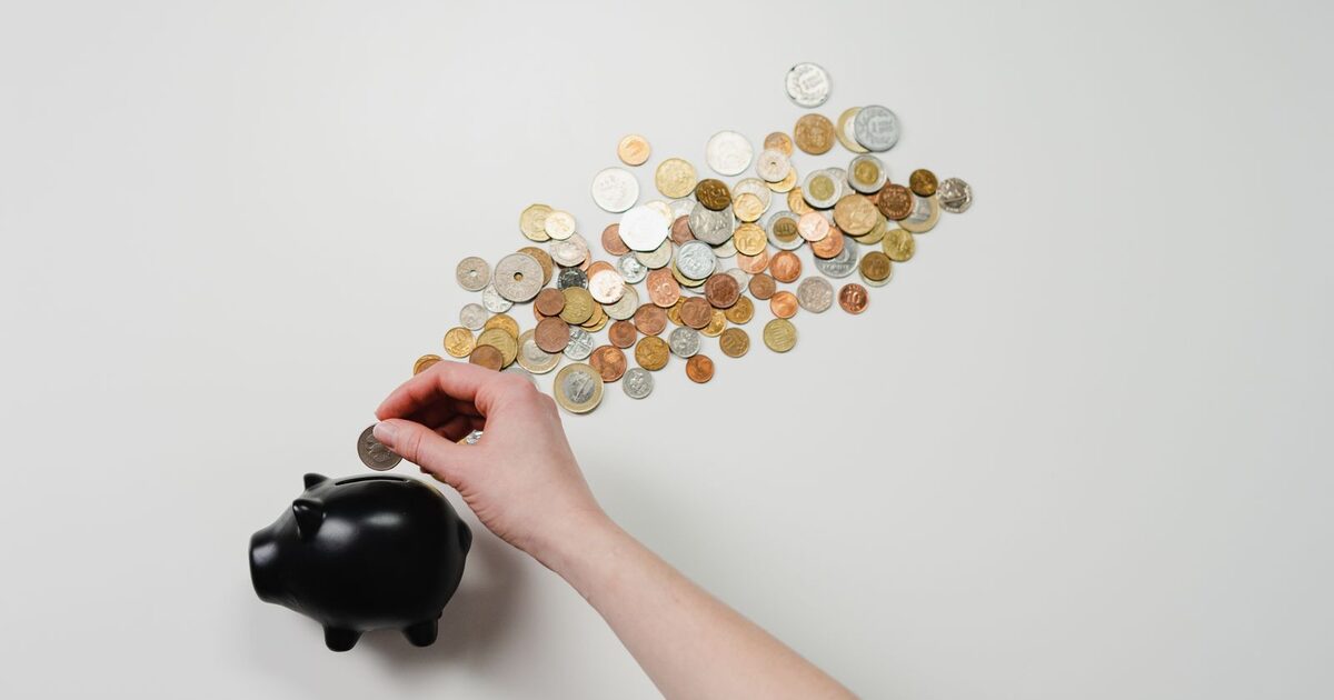 A jar of savings and home documents representing a home maintenance fund